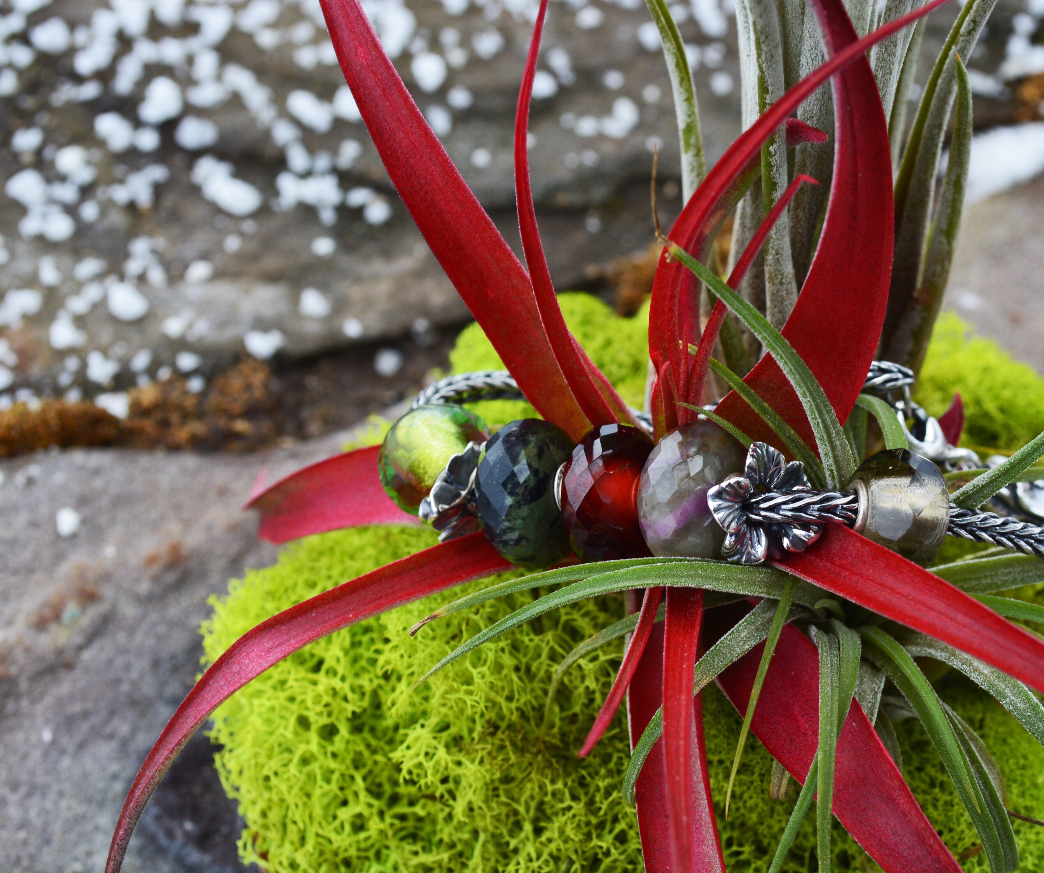 A photos of deep greens and garnets featuring a design by Trollbeadsakron.com