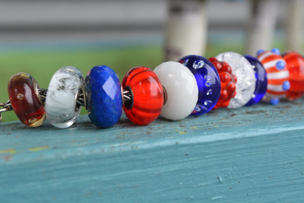 A collection of Red white and Blue Glass Trollbeads