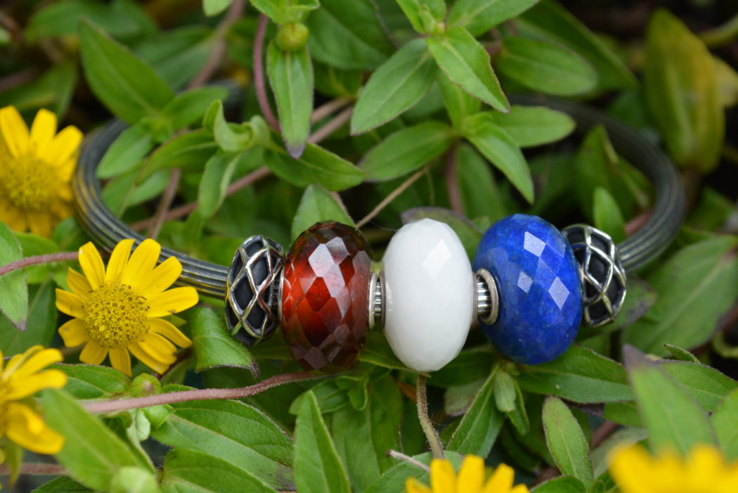 This patriotic bangle features 3 faceted stone in red white and blue on a textured star bangle.