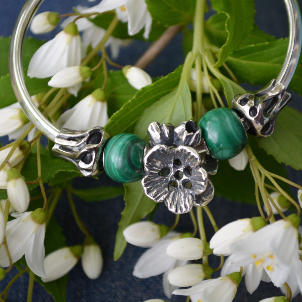 A bangle featuring new Trollbeads Summer Malachite Beads