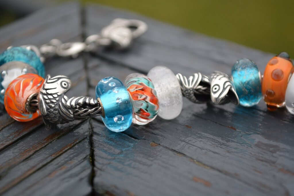 Trollbeads Carp Koi inspiration image. Trollbeads orange and blue glass bracelet with silver Carp Koi pendants 